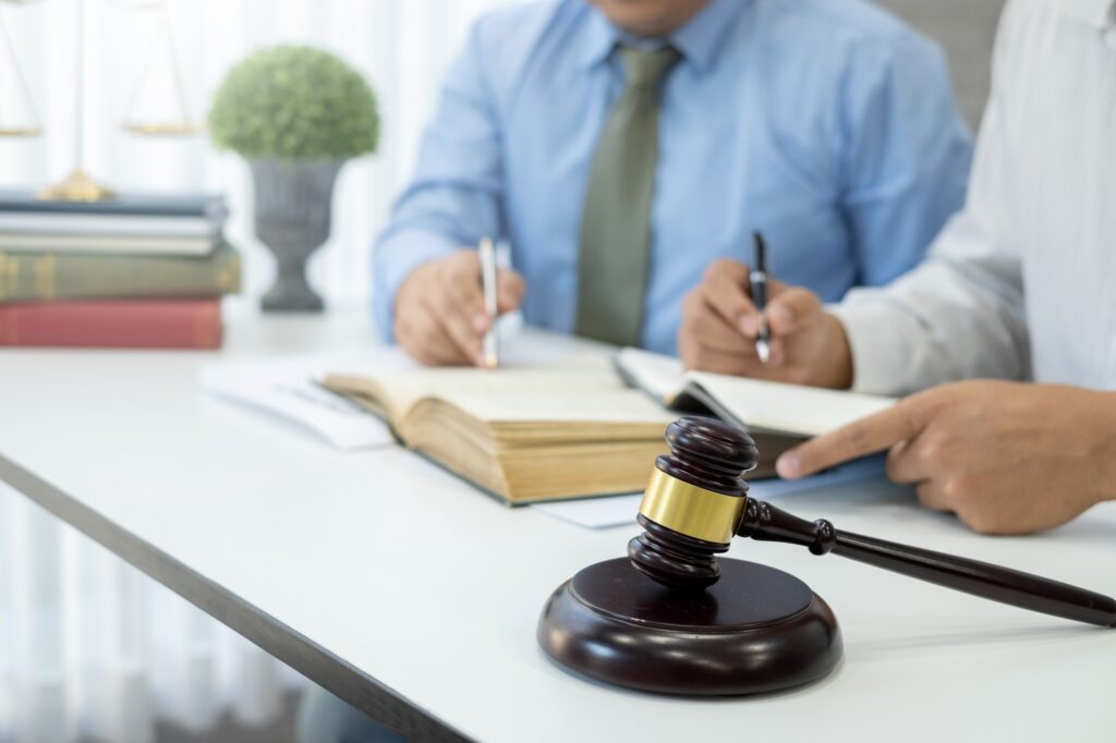 Lawyers team discuss legal matters to assist clients in legal litigation.